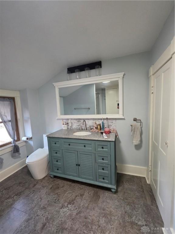 126 S Maple St, Eaton, OH 45320 - bathroom featuring vanity, backsplash, and lofted ceiling