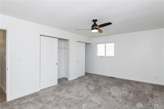 7044 Park Vista Rd, Englewood, OH 45322 - unfurnished bedroom with carpet floors, two closets, and a ceiling fan