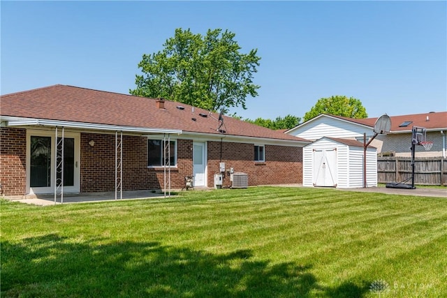 7044 Park Vista Rd, Englewood, OH 45322 - back of house with a shed, brick siding, a patio, and a shingled roof