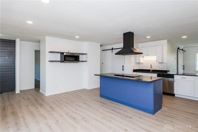 7044 Park Vista Rd, Englewood, OH 45322 - kitchen featuring island exhaust hood, stainless steel appliances, a barn door, light wood finished floors, and recessed lighting