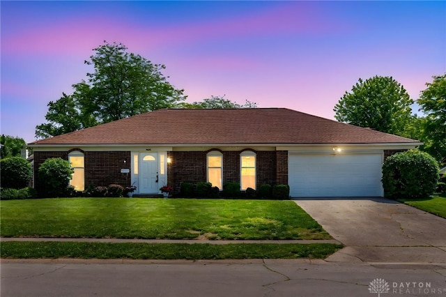 7044 Park Vista Rd, Englewood, OH 45322 - single story home with concrete driveway, an attached garage, a yard, and brick siding