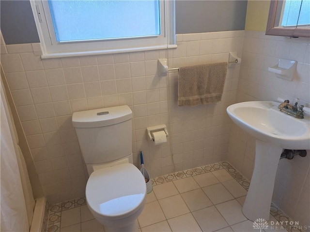 291 Chamberlin Rd, Carlisle, OH 45005 - bathroom with tile walls, healthy amount of natural light, a shower with shower curtain, tile patterned flooring, and a wainscoted wall