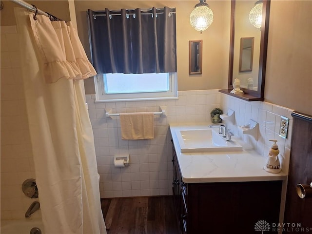 291 Chamberlin Rd, Carlisle, OH 45005 - bathroom with tile walls, vanity, wainscoting, shower / bath combo with shower curtain, and wood finished floors