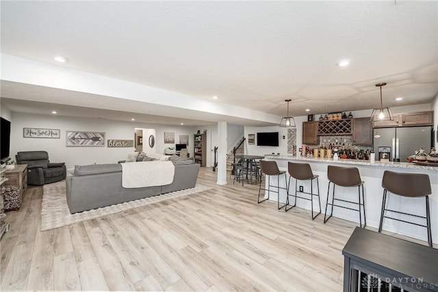 5078 Magellan Way, Franklin, OH 45005 - living room with wet bar, light wood-style floors, recessed lighting, and stairway