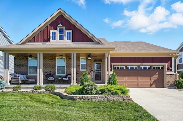 5078 Magellan Way, Franklin, OH 45005 - view of front facade with board and batten siding, a ceiling fan, a front lawn, and brick siding