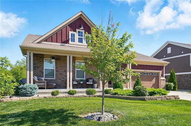 5078 Magellan Way, Franklin, OH 45005 - view of front facade featuring board and batten siding, covered porch, a front lawn, a ceiling fan, and driveway