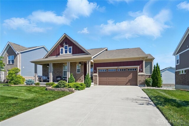 5078 Magellan Way, Franklin, OH 45005 - craftsman-style house featuring board and batten siding, a front lawn, an attached garage, and covered porch