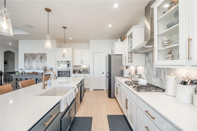 5078 Magellan Way, Franklin, OH 45005 - kitchen featuring wall chimney exhaust hood, stainless steel appliances, white cabinetry, light countertops, and hanging light fixtures