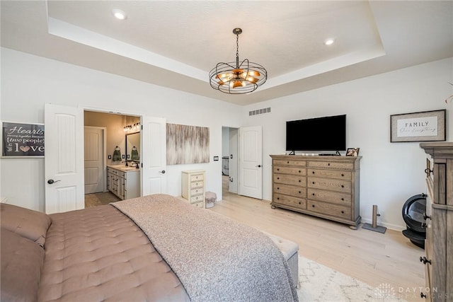 5078 Magellan Way, Franklin, OH 45005 - bedroom featuring a raised ceiling, light wood finished floors, recessed lighting, a chandelier, and connected bathroom