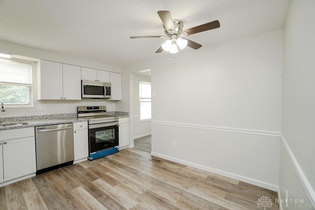 2949 N Bend Rd, Cincinnati, OH 45239 - kitchen with stainless steel appliances, healthy amount of natural light, light wood-style floors, and a ceiling fan