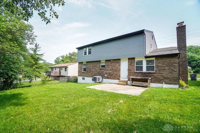 2949 N Bend Rd, Cincinnati, OH 45239 - back of property with brick siding, entry steps, a patio, and a chimney