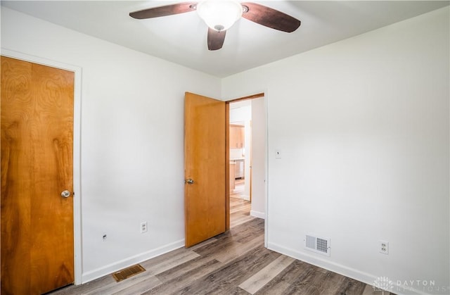 235 Stonequarry Rd, Vandalia, OH 45377 - unfurnished bedroom featuring wood finished floors and a ceiling fan