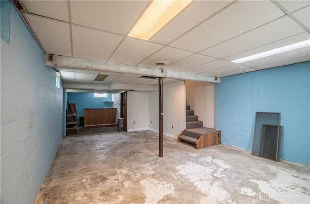 235 Stonequarry Rd, Vandalia, OH 45377 - below grade area featuring stairway, a drop ceiling, and concrete block wall