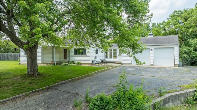 235 Stonequarry Rd, Vandalia, OH 45377 - obstructed view of property featuring a garage, asphalt driveway, and a chimney