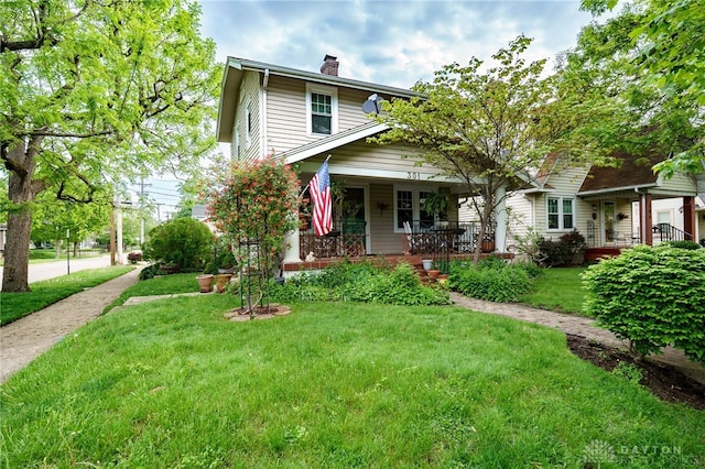 301 E Peach Orchard Ave, Oakwood, OH 45419 - american foursquare style home with covered porch, a chimney, and a front lawn