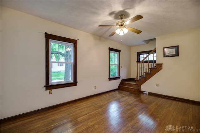 301 E Peach Orchard Ave, Oakwood, OH 45419 - empty room featuring healthy amount of natural light, wood finished floors, stairway, and a ceiling fan