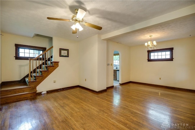301 E Peach Orchard Ave, Oakwood, OH 45419 - empty room with plenty of natural light, arched walkways, wood finished floors, and stairs