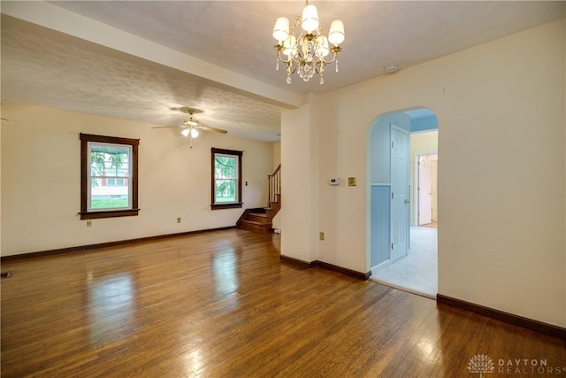 301 E Peach Orchard Ave, Oakwood, OH 45419 - spare room with arched walkways, hardwood / wood-style floors, stairway, ceiling fan, and a chandelier