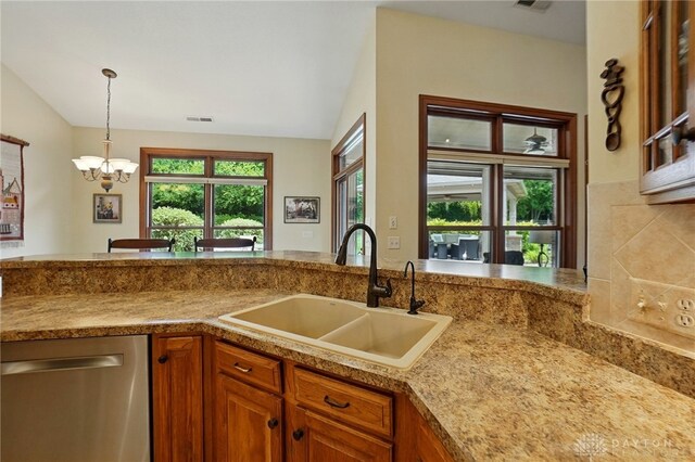 1106 Roger Scott Dr, Bellbrook, OH 45305 - kitchen featuring stainless steel dishwasher, brown cabinets, vaulted ceiling, a chandelier, and pendant lighting