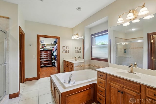 1106 Roger Scott Dr, Bellbrook, OH 45305 - bathroom featuring a stall shower, vanity, a spacious closet, tile patterned flooring, and a bath