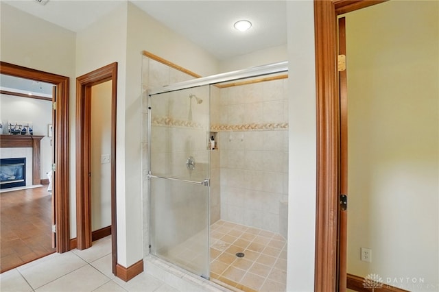 1106 Roger Scott Dr, Bellbrook, OH 45305 - full bath with a shower stall, tile patterned flooring, and a glass covered fireplace