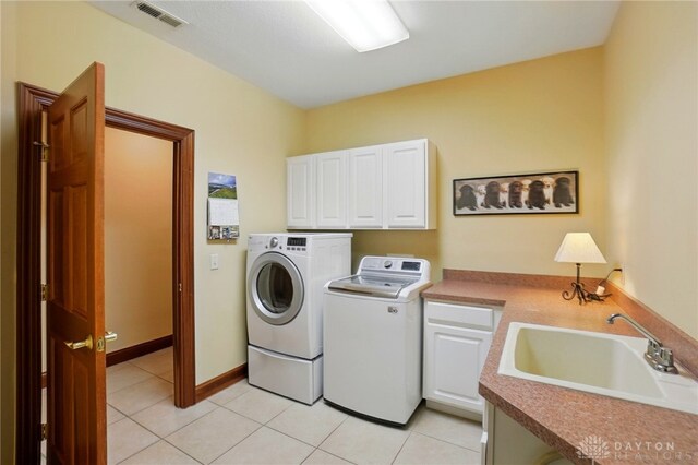 1106 Roger Scott Dr, Bellbrook, OH 45305 - laundry room with cabinet space, washer and dryer, and light tile patterned floors