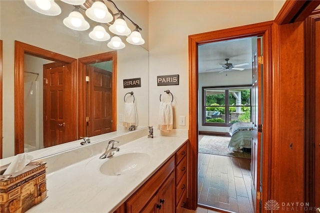 1106 Roger Scott Dr, Bellbrook, OH 45305 - bathroom featuring vanity, wood finished floors, ensuite bath, a chandelier, and a ceiling fan
