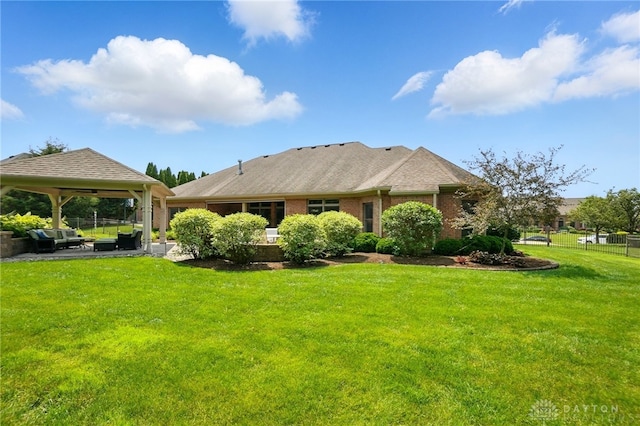 1106 Roger Scott Dr, Bellbrook, OH 45305 - back of house featuring a gazebo, an outdoor living space, brick siding, and a patio
