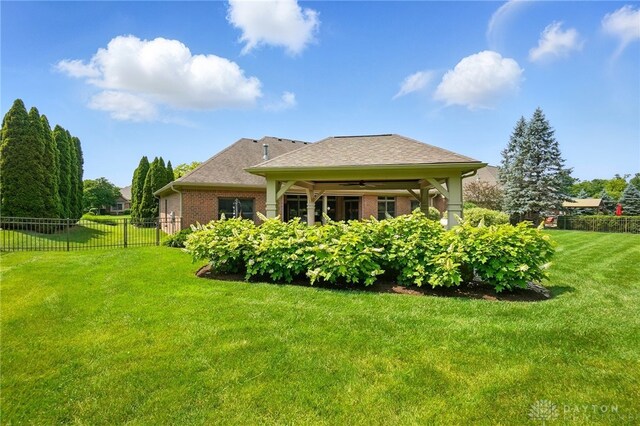 1106 Roger Scott Dr, Bellbrook, OH 45305 - back of property featuring ceiling fan, brick siding, and a shingled roof