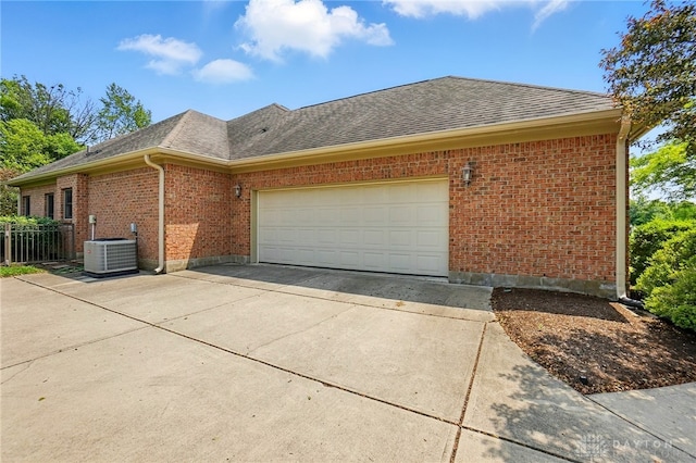 1106 Roger Scott Dr, Bellbrook, OH 45305 - view of home's exterior with concrete driveway, brick siding, an attached garage, and a shingled roof
