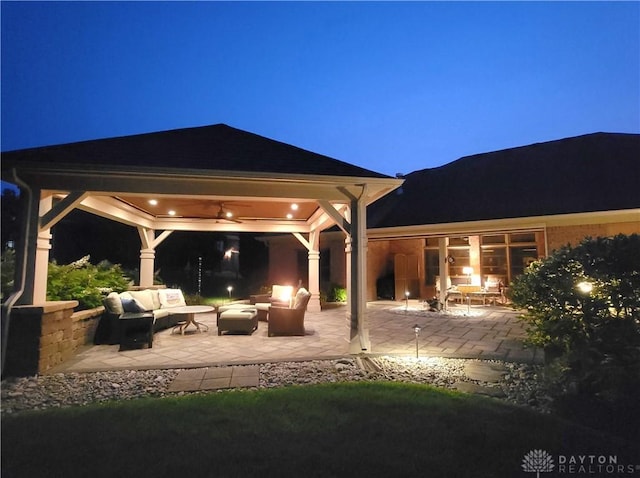 1106 Roger Scott Dr, Bellbrook, OH 45305 - patio at night with a gazebo, an outdoor hangout area, and a patio