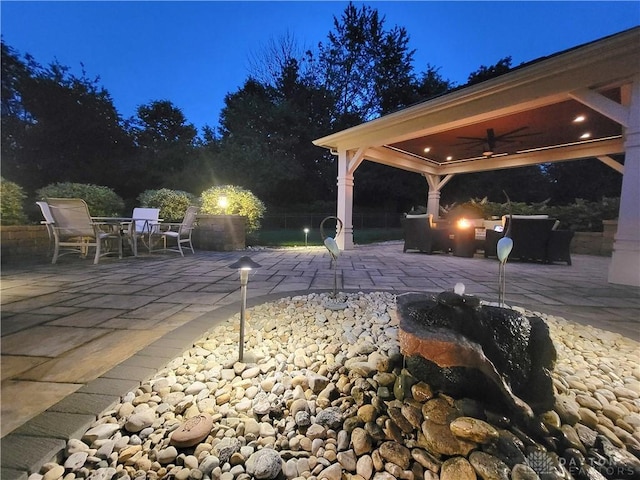 1106 Roger Scott Dr, Bellbrook, OH 45305 - patio at night featuring a ceiling fan, a patio area, outdoor dining area, and a gazebo