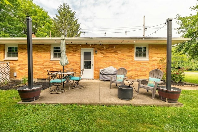 2435 S County Road 25a, Troy, OH 45373 - rear view of house featuring brick siding, a yard, a patio, and crawl space