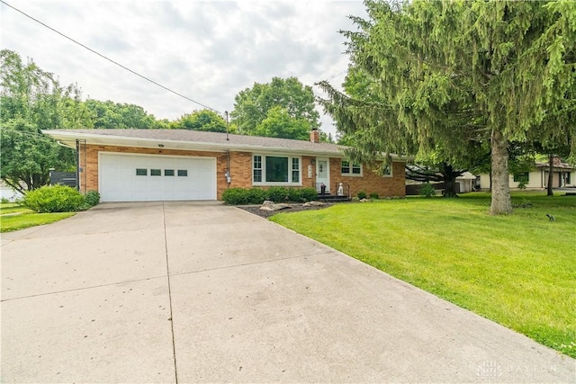 2435 S County Road 25a, Troy, OH 45373 - single story home with a garage, concrete driveway, brick siding, a front lawn, and a chimney