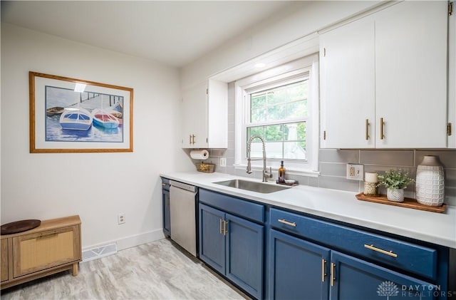 2435 S County Road 25a, Troy, OH 45373 - kitchen with blue cabinets, dishwasher, light countertops, and white cabinetry