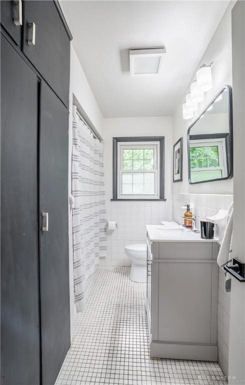 2435 S County Road 25a, Troy, OH 45373 - bathroom with vanity, tile walls, and tile patterned flooring