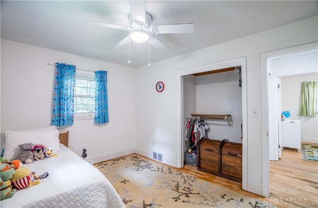 2435 S County Road 25a, Troy, OH 45373 - bedroom with wood finished floors, a ceiling fan, and a closet