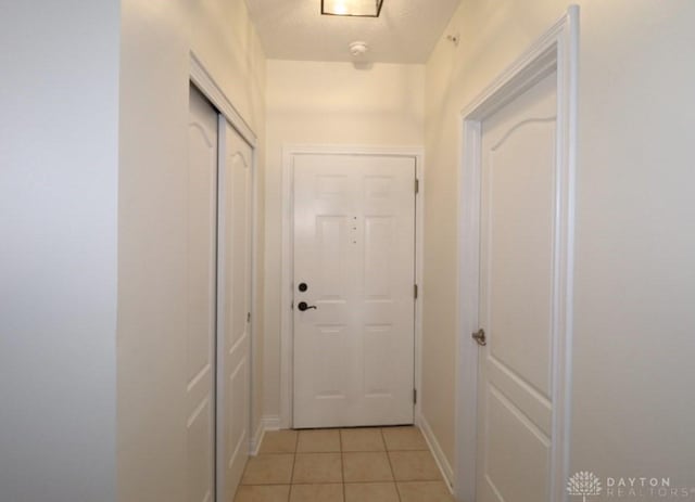 3224 Grand Falls Blvd, Maineville, OH 45039 - doorway with light tile patterned floors and baseboards