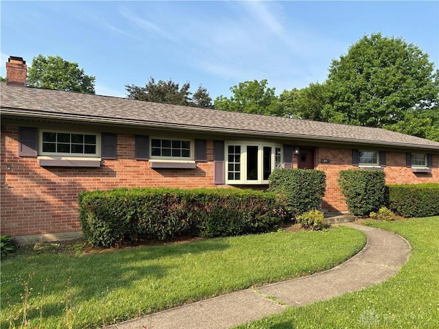 215 W Martindale Rd, Englewood, OH 45322 - ranch-style house featuring brick siding, a front lawn, a chimney, and a shingled roof