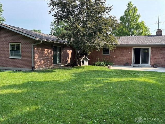 215 W Martindale Rd, Englewood, OH 45322 - view of grassy yard with a patio