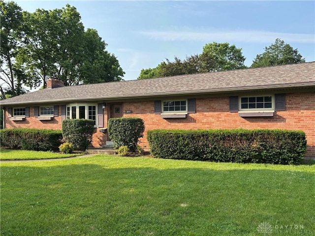 215 W Martindale Rd, Englewood, OH 45322 - ranch-style home with brick siding, a chimney, and a front yard