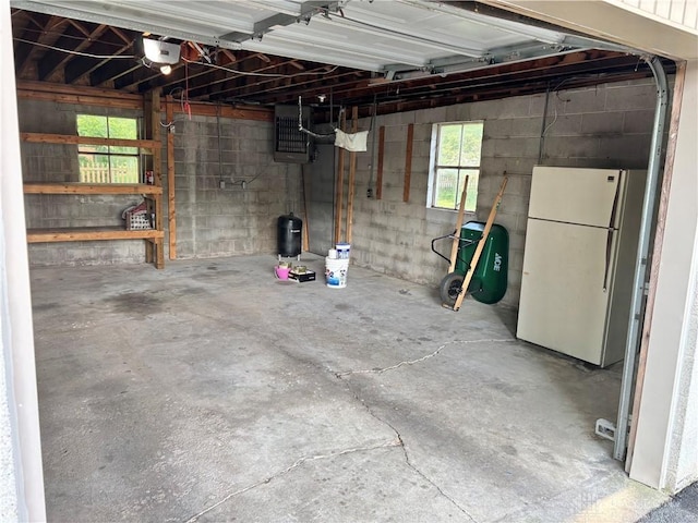 215 W Martindale Rd, Englewood, OH 45322 - garage featuring freestanding refrigerator and a garage door opener