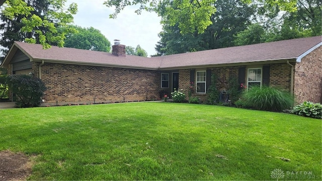 5468 Split Rock Dr, Dayton, OH 45424 - ranch-style house featuring brick siding, a chimney, an attached garage, and a front lawn