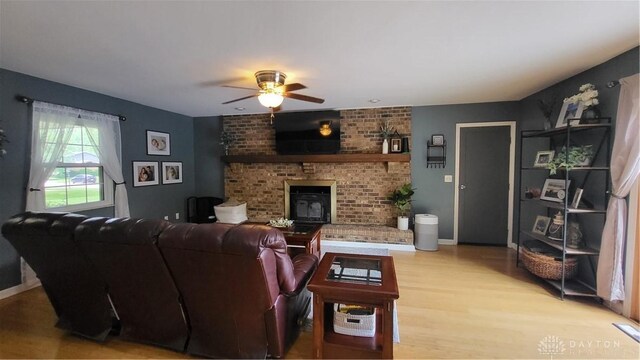 5468 Split Rock Dr, Dayton, OH 45424 - living area with light wood-style floors, a ceiling fan, and a brick fireplace