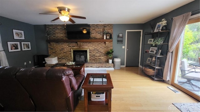 5468 Split Rock Dr, Dayton, OH 45424 - living area with ceiling fan, light wood-type flooring, and a fireplace