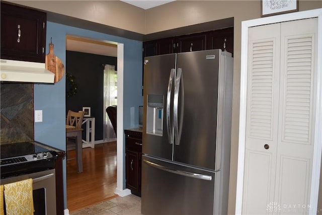 5468 Split Rock Dr, Dayton, OH 45424 - kitchen featuring appliances with stainless steel finishes, exhaust hood, dark brown cabinets, and light wood-type flooring