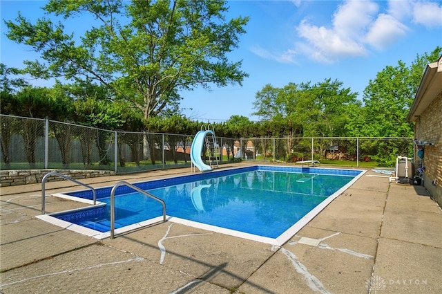 2946 Rockledge Trl, Beavercreek, OH 45430 - view of swimming pool with a water slide, a fenced backyard, a patio, and a diving board