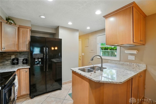 2946 Rockledge Trl, Beavercreek, OH 45430 - kitchen featuring black appliances, a peninsula, light stone countertops, light tile patterned floors, and a textured ceiling