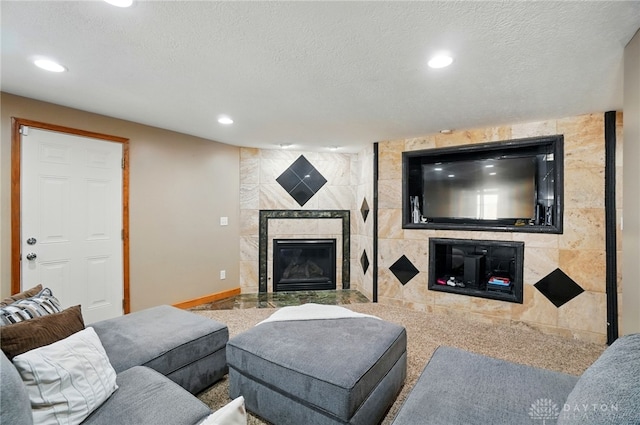 2946 Rockledge Trl, Beavercreek, OH 45430 - living room featuring a tiled fireplace, recessed lighting, and a textured ceiling