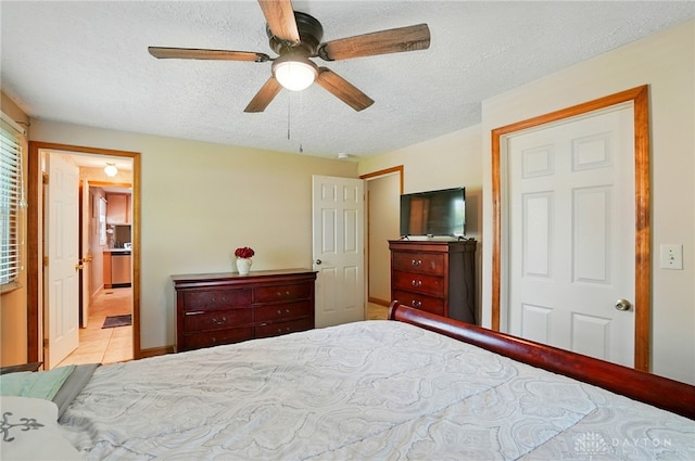 2946 Rockledge Trl, Beavercreek, OH 45430 - tiled bedroom featuring a textured ceiling, a ceiling fan, and ensuite bathroom